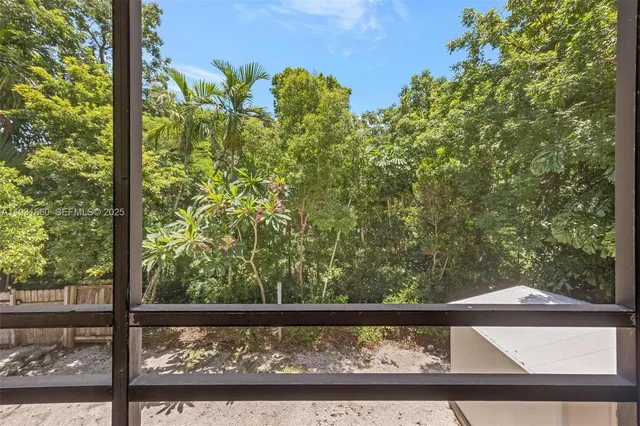 a view of a porch with furniture and wooden floor