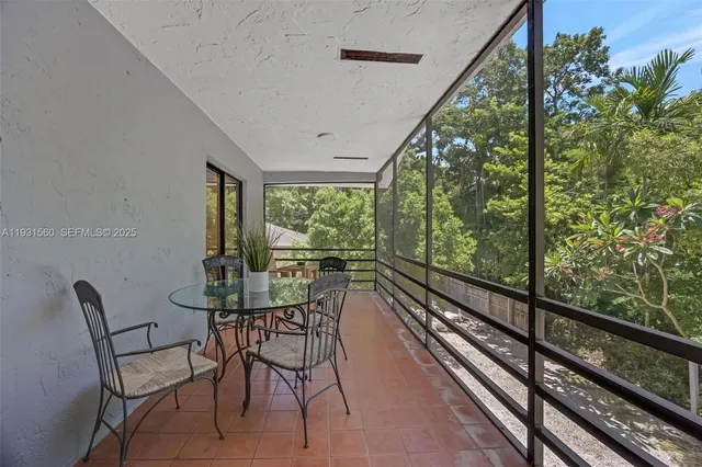 a view of a porch with furniture and wooden floor