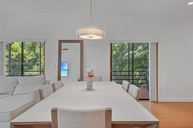 a view of a dining room with furniture wooden floor and chandelier