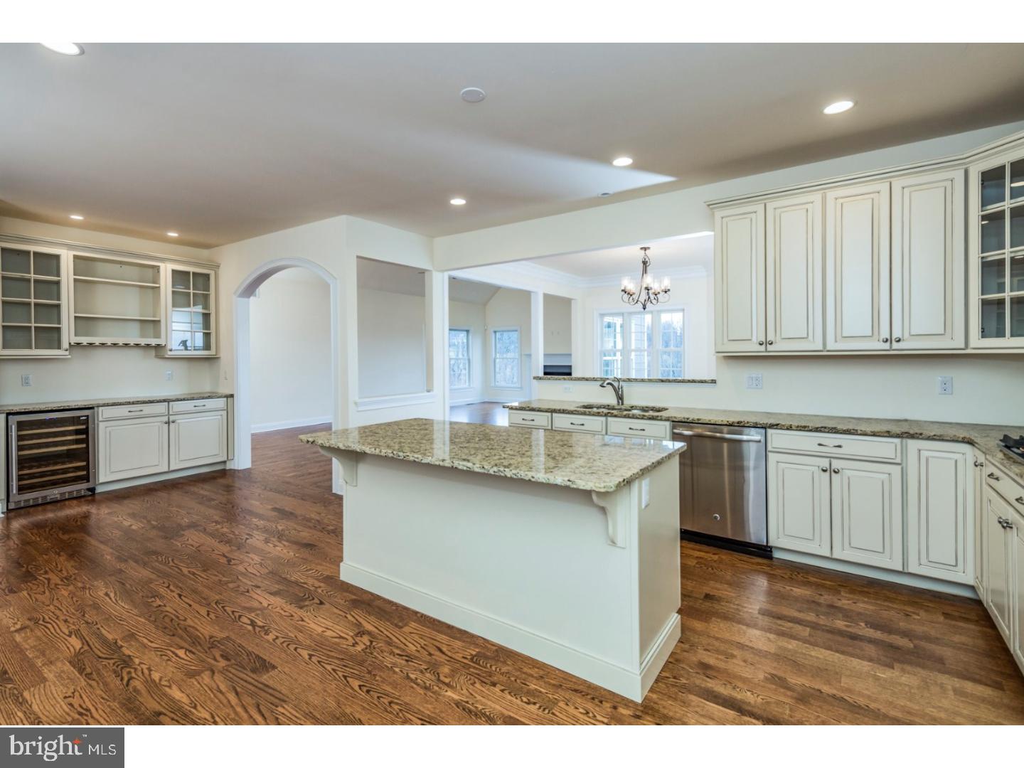 14 Partridge Road Flemington, NJ 08822 - Photo 9 of 24 a kitchen with granite countertop a stove a sink and white cabinets with wooden floor