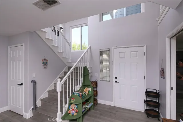 a view of an entryway with wooden floor and stairs