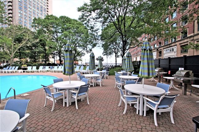 a view of a patio with a dining table and chairs with a garden