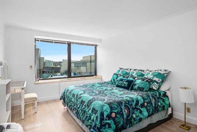 a bed sitting in a bedroom next to a window