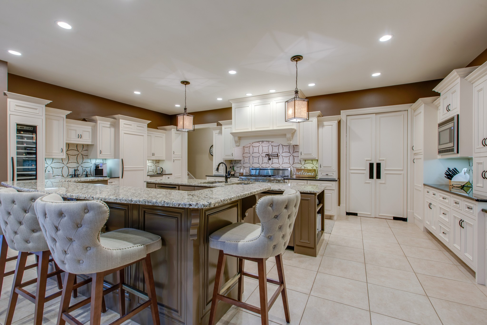 4200 Two Rivers Lane Franklin, TN 37069 - Photo 12 of 44 a kitchen with stainless steel appliances kitchen island granite countertop a table chairs and a refrigerator