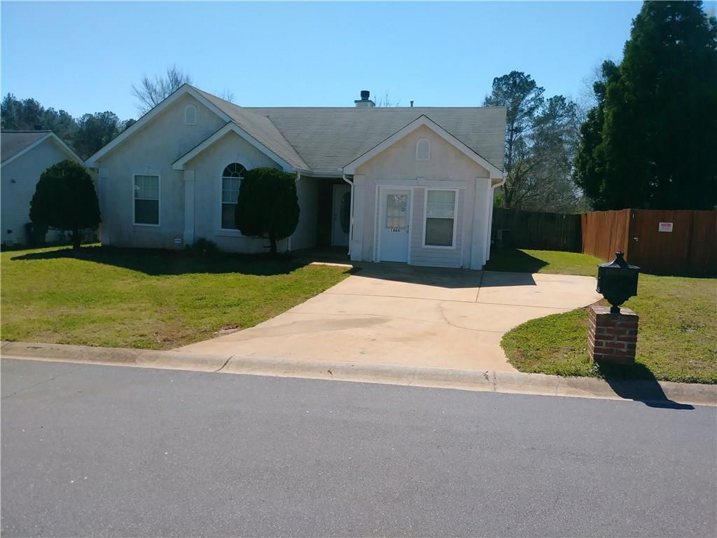 1864 Portwest Way Hampton, GA 30228 - Photo 1 of 1 a front view of a house with a yard and garage