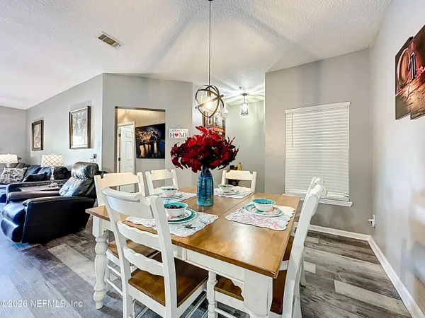 a view of a dining room with furniture window and wooden floor