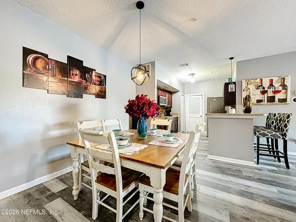 a view of a dining room with furniture and chandelier