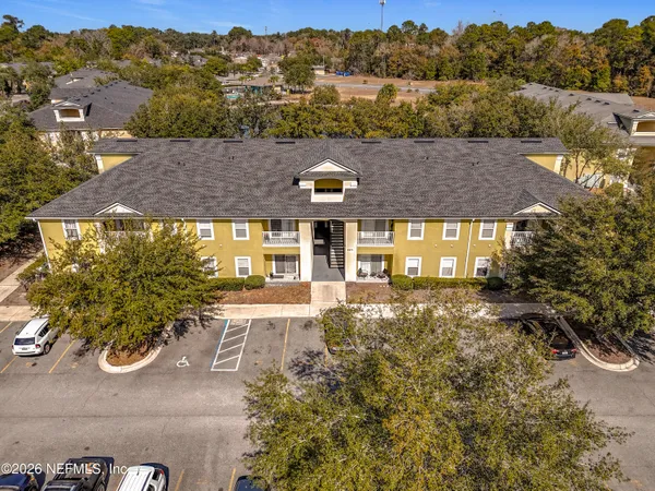 an aerial view of a house with a yard basket ball court and outdoor seating