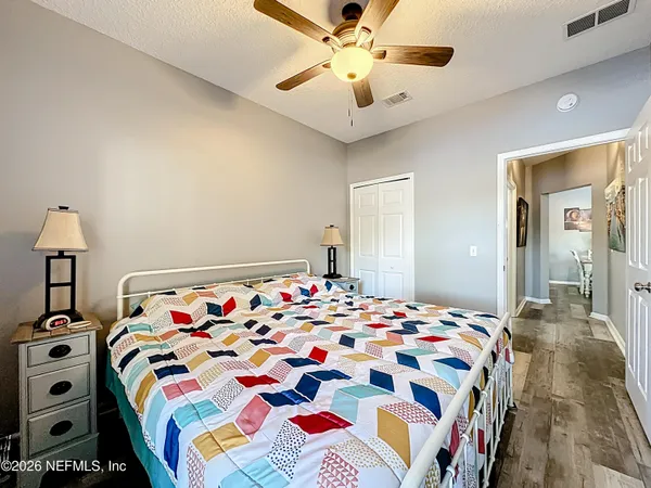 a bedroom with bed and a chandelier