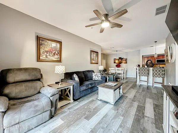 a living room with furniture and white walls