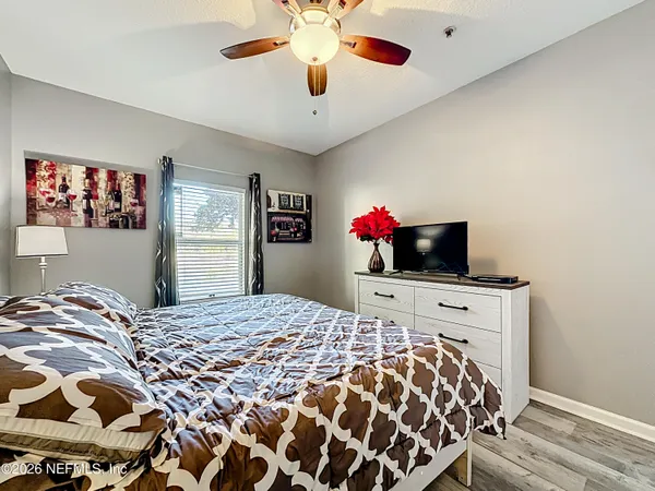 a bedroom with a large bed and a flat screen tv