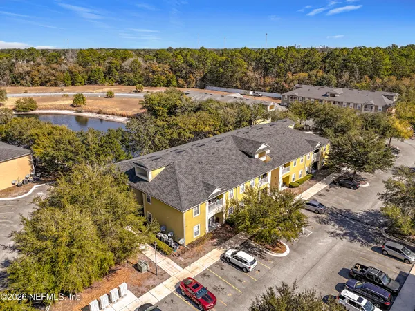 an aerial view of residential houses with outdoor space