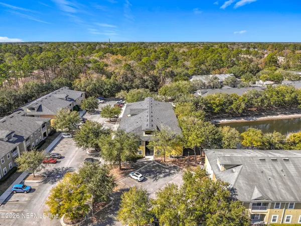 an aerial view of residential houses with outdoor space and swimming pool
