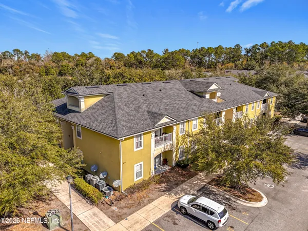 a aerial view of a house with a yard