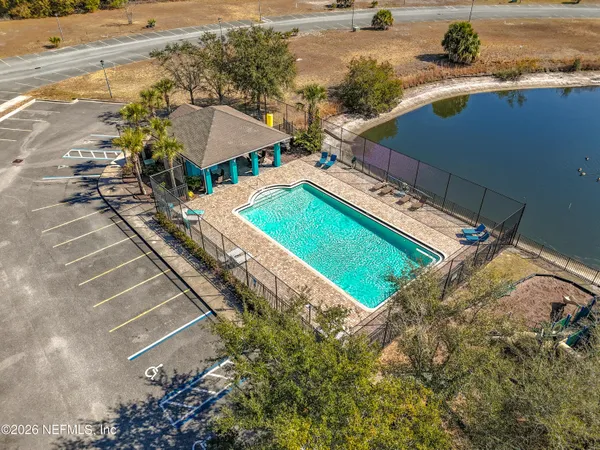 a view of a tennis ground with a large pool