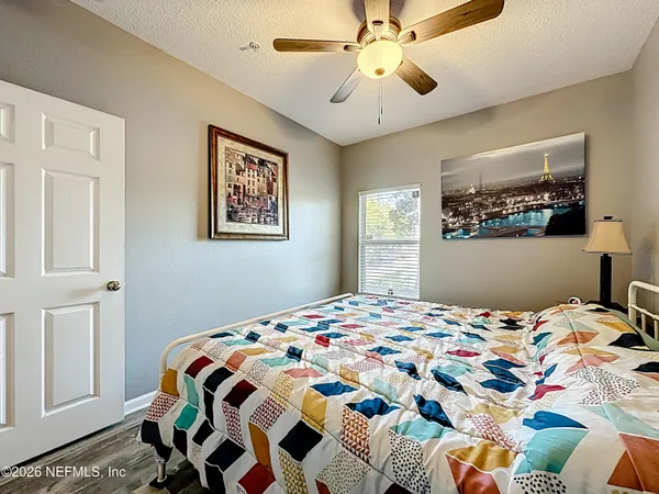 a bedroom with a bed and a chandelier