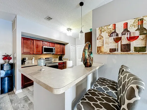 a kitchen with a sink a stove and storage