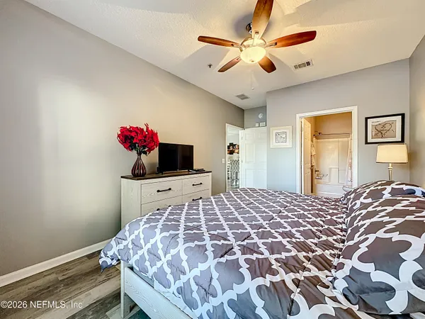 a bedroom with a bed and a chandelier