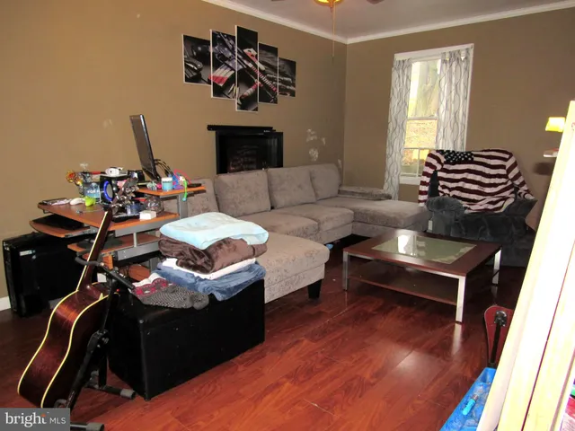 a living room with furniture a rug and a flat screen tv