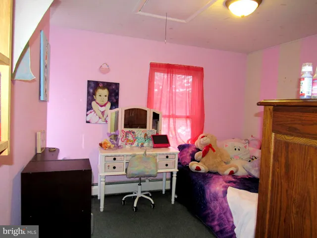 a bedroom with a bed and a tv in it