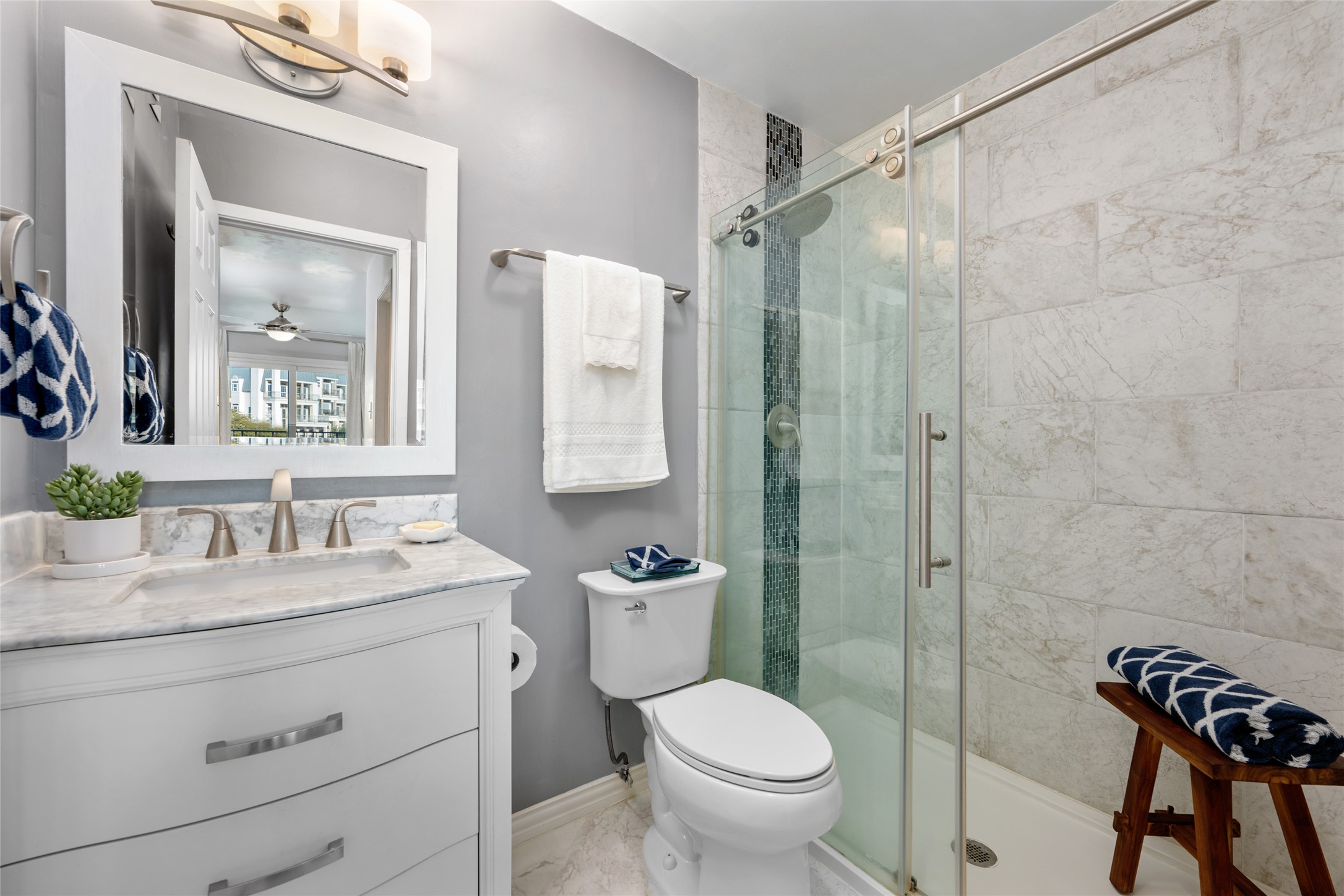 2918 Ranch Road 620 North, Unit C120 Austin, TX 78734 - Photo 30 of 38 a bathroom with a granite countertop sink a toilet a mirror and shower