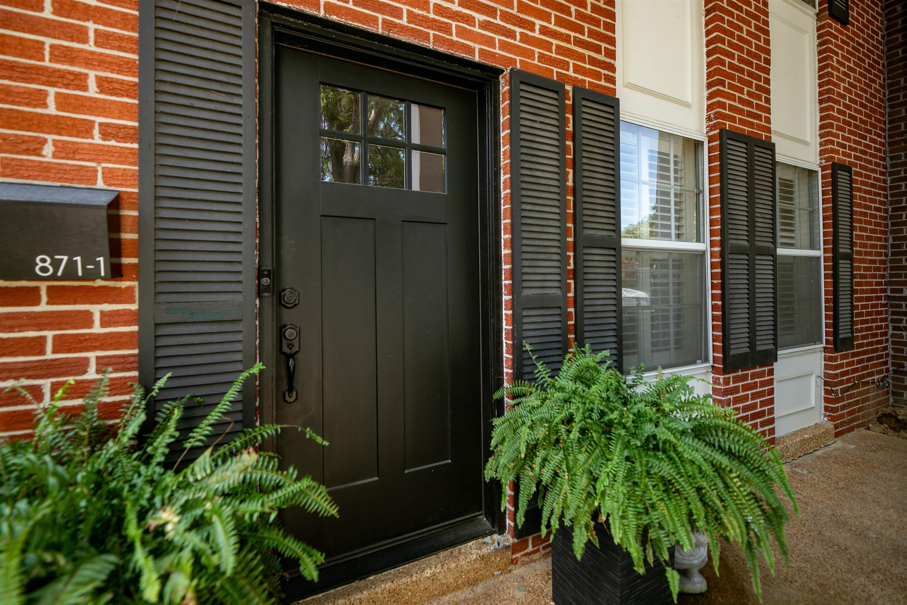 871 South Yates Road, Unit 1 Memphis, TN 38120 - Photo 2 of 23 a potted plant sitting in front of a house