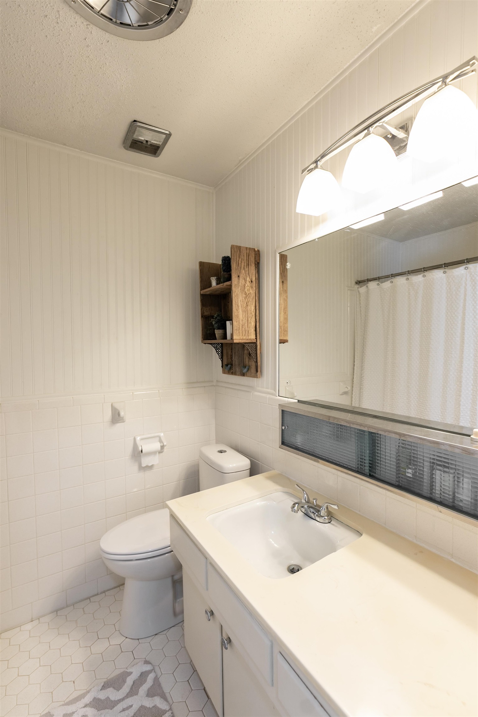 871 South Yates Road, Unit 1 Memphis, TN 38120 - Photo 21 of 23 a bathroom with a sink a toilet and a mirror