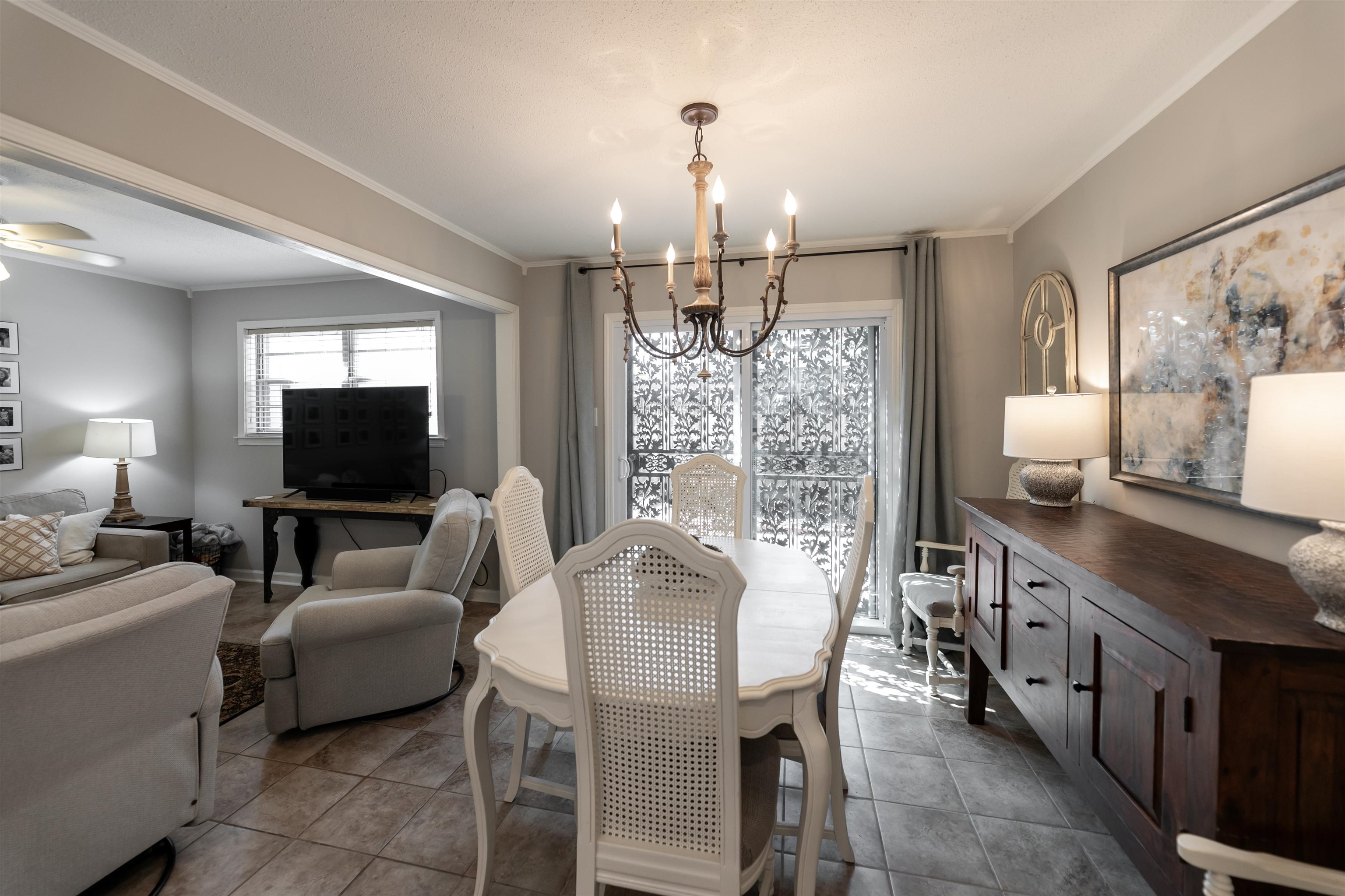 871 South Yates Road, Unit 1 Memphis, TN 38120 - Photo 8 of 23 a living room with furniture a chandelier and a flat screen tv