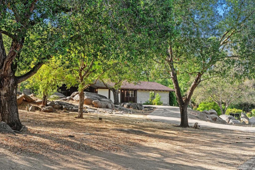 16522 Orchard Bend Road Poway, CA 92064 - Photo 18 of 26 a front view of a house with a yard