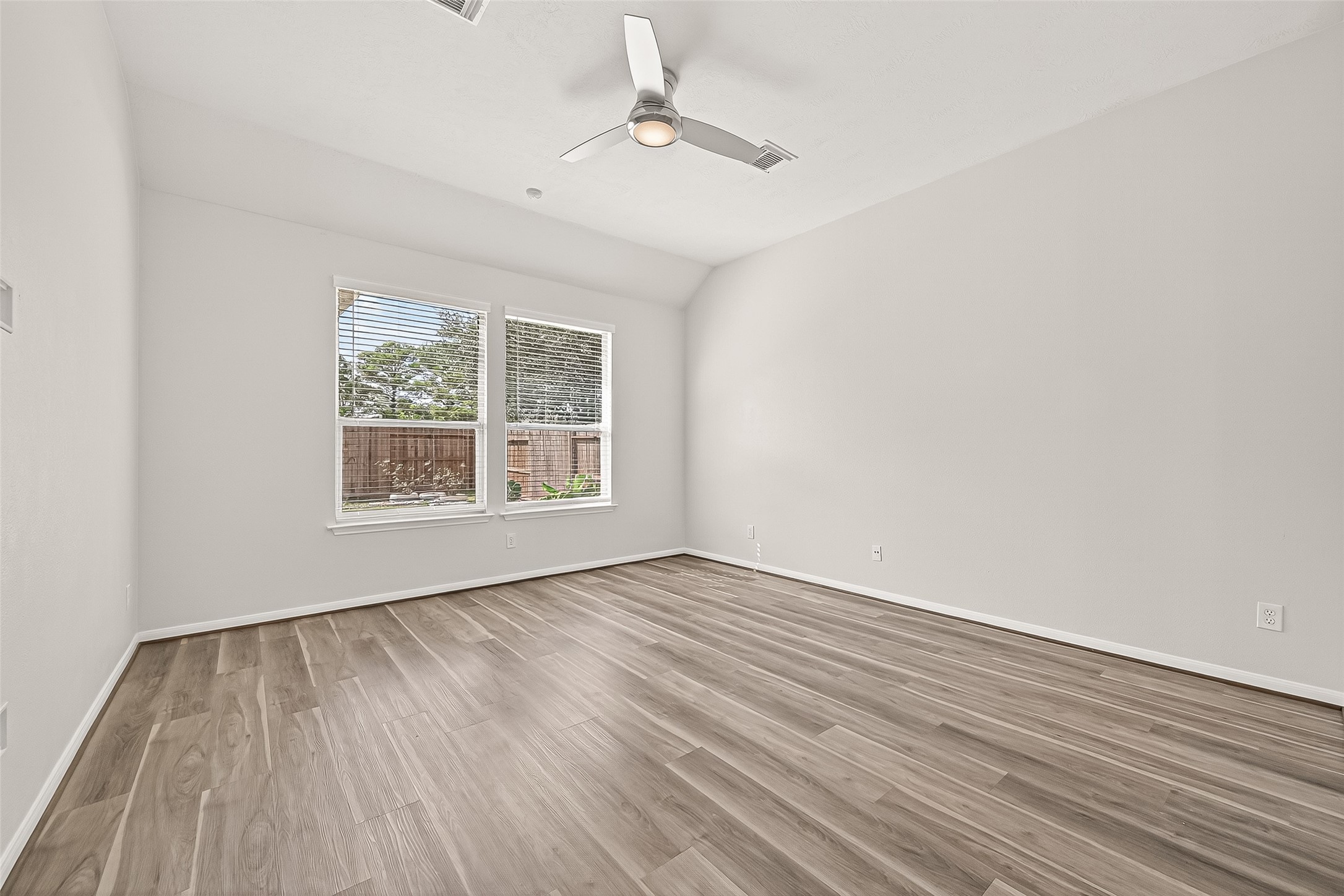 19343 Dickson Park Drive Spring, TX 77373 - Photo 14 of 49 wooden floor in an empty room with a window
