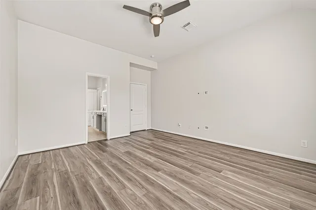 a kitchen with cabinets a window and chairs
