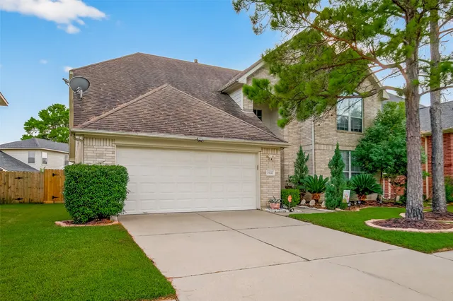 a view of a hallway with wooden floor and a window