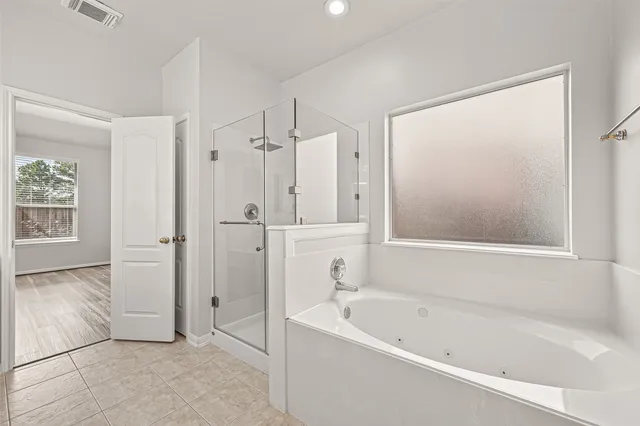 a living room with furniture a ceiling fan a lamp and a window