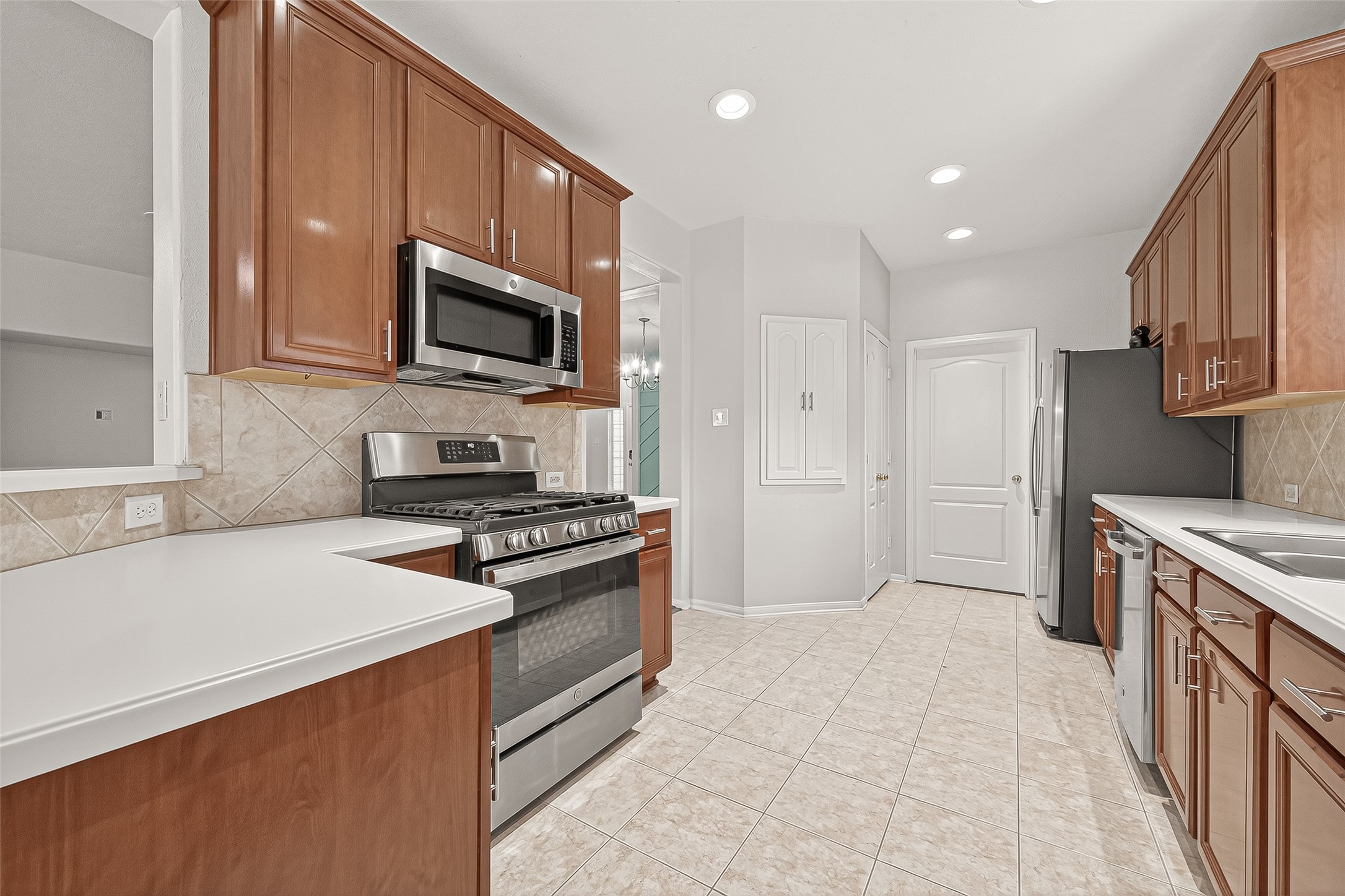19343 Dickson Park Drive Spring, TX 77373 - Photo 27 of 49 a kitchen with stainless steel appliances granite countertop a stove a sink and a refrigerator