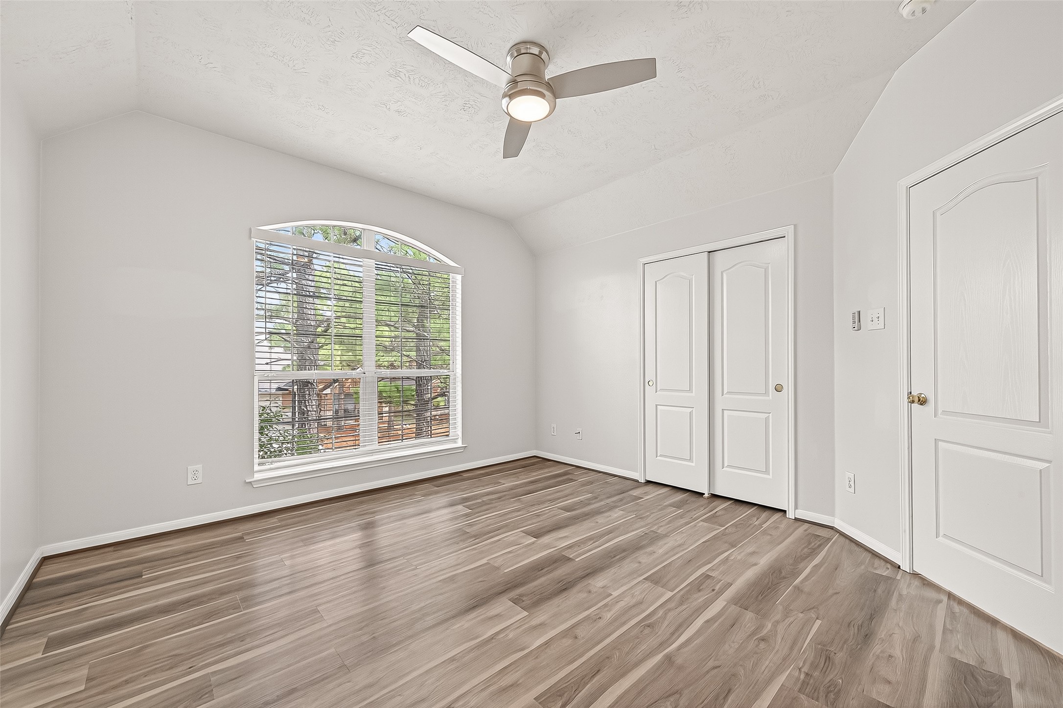 19343 Dickson Park Drive Spring, TX 77373 - Photo 31 of 49 an empty room with wooden floor ceiling fan and windows