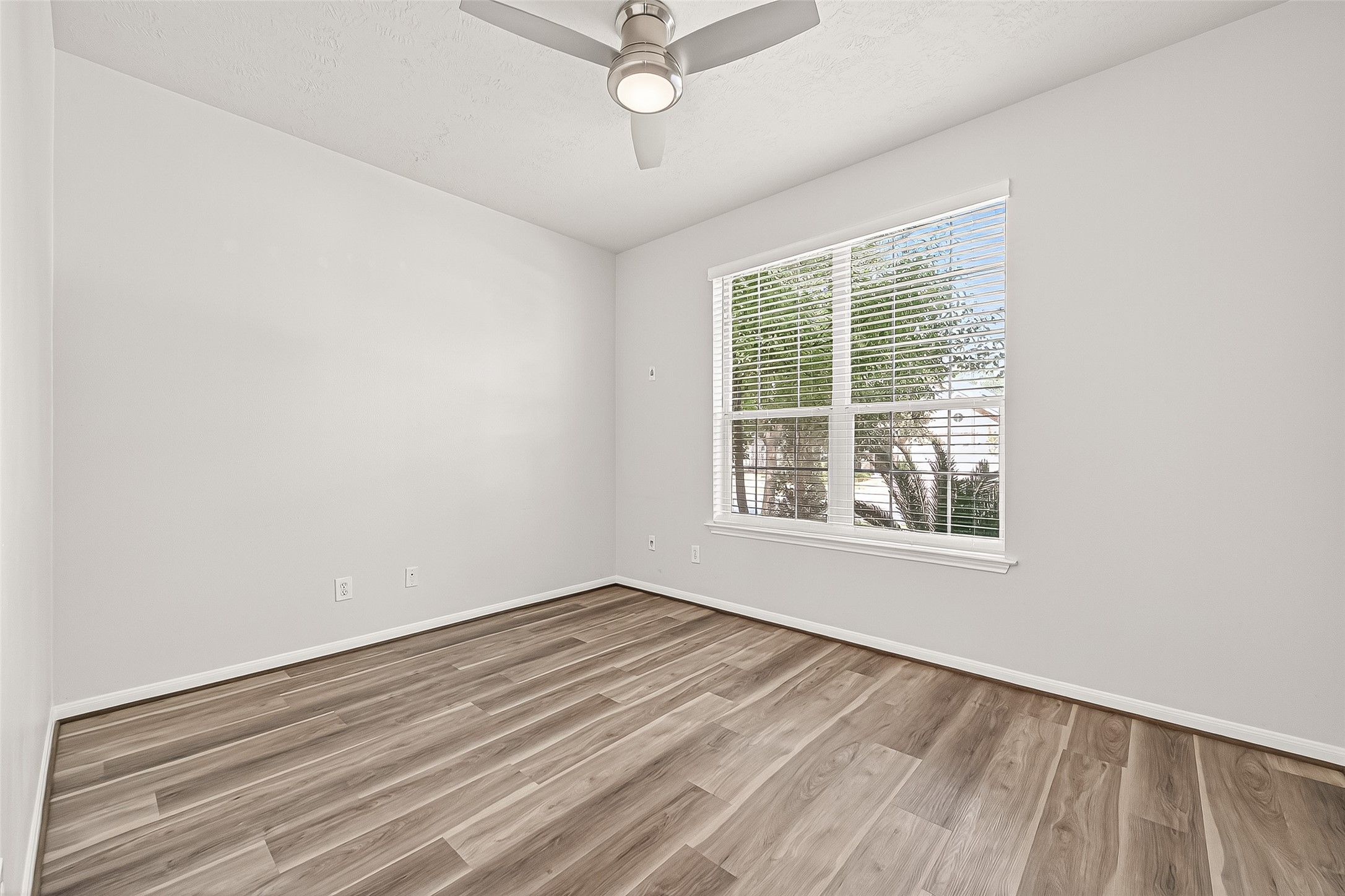 19343 Dickson Park Drive Spring, TX 77373 - Photo 39 of 49 a view of an empty room with wooden floor and a window