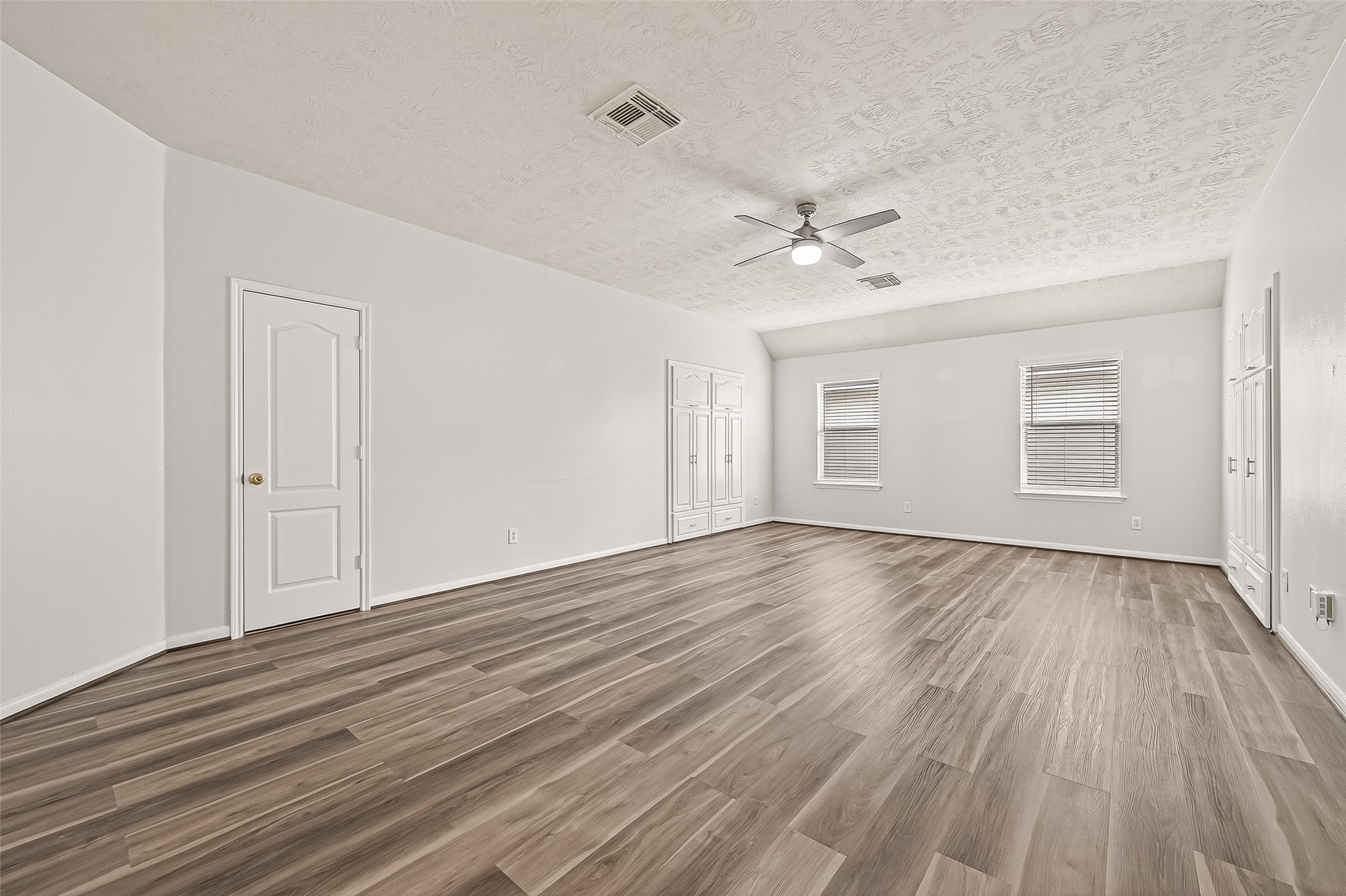 19343 Dickson Park Drive Spring, TX 77373 - Photo 41 of 49 a view of an empty room with wooden floor and a ceiling fan