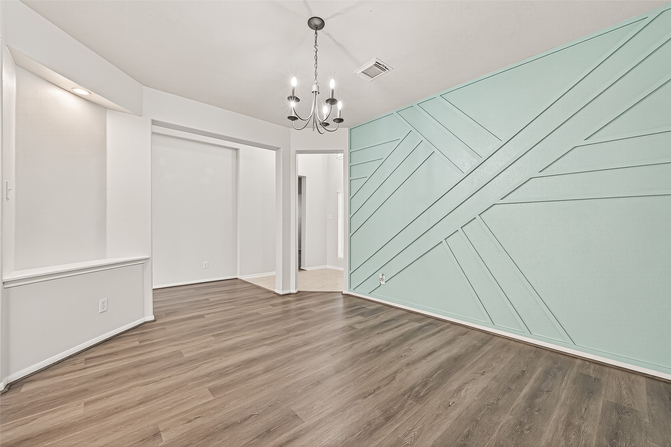 19343 Dickson Park Drive Spring, TX 77373 - Photo 8 of 49 an empty room with wooden floor chandelier and windows