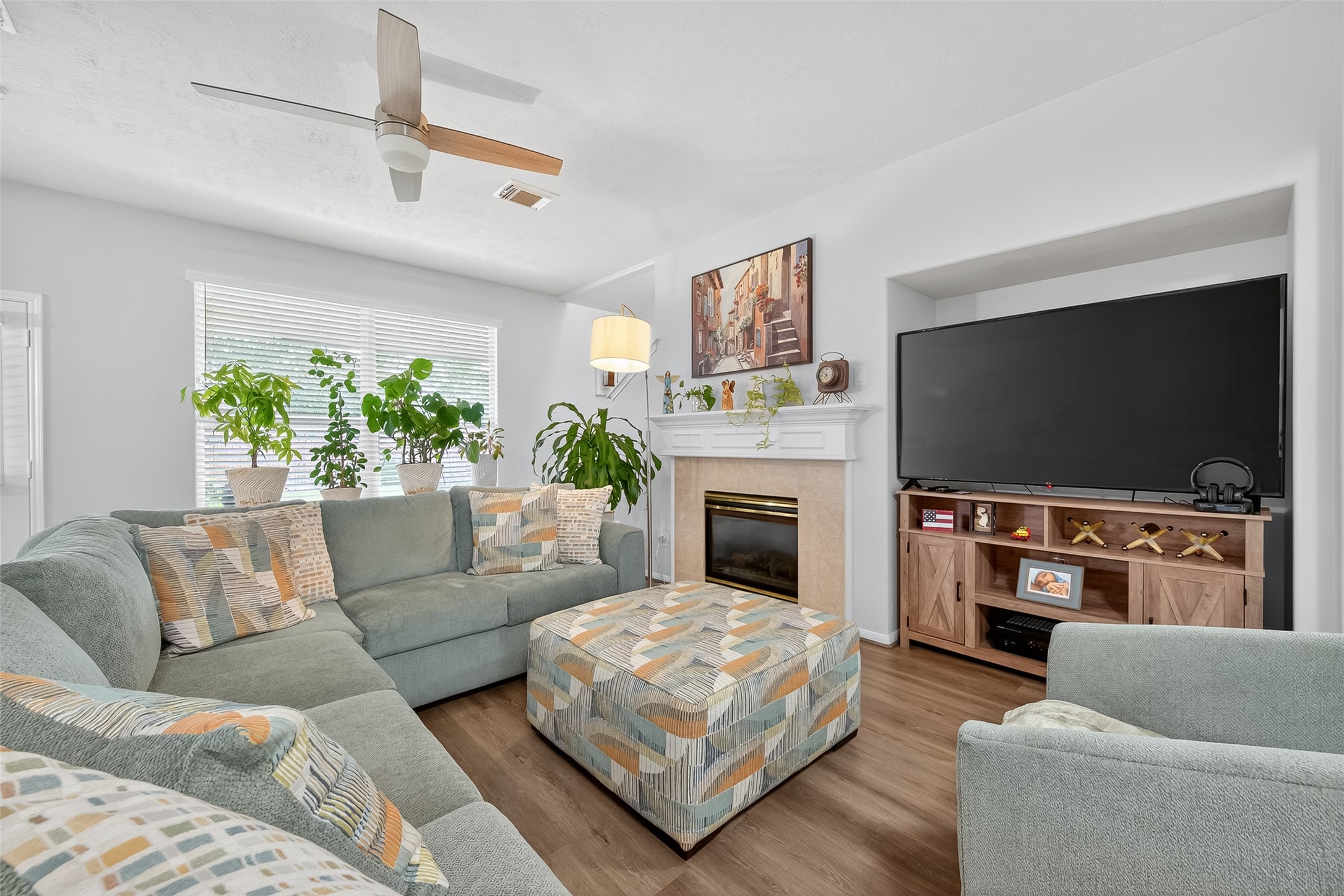 19343 Dickson Park Drive Spring, TX 77373 - Photo 9 of 49 a living room with furniture a flat screen tv and a fireplace