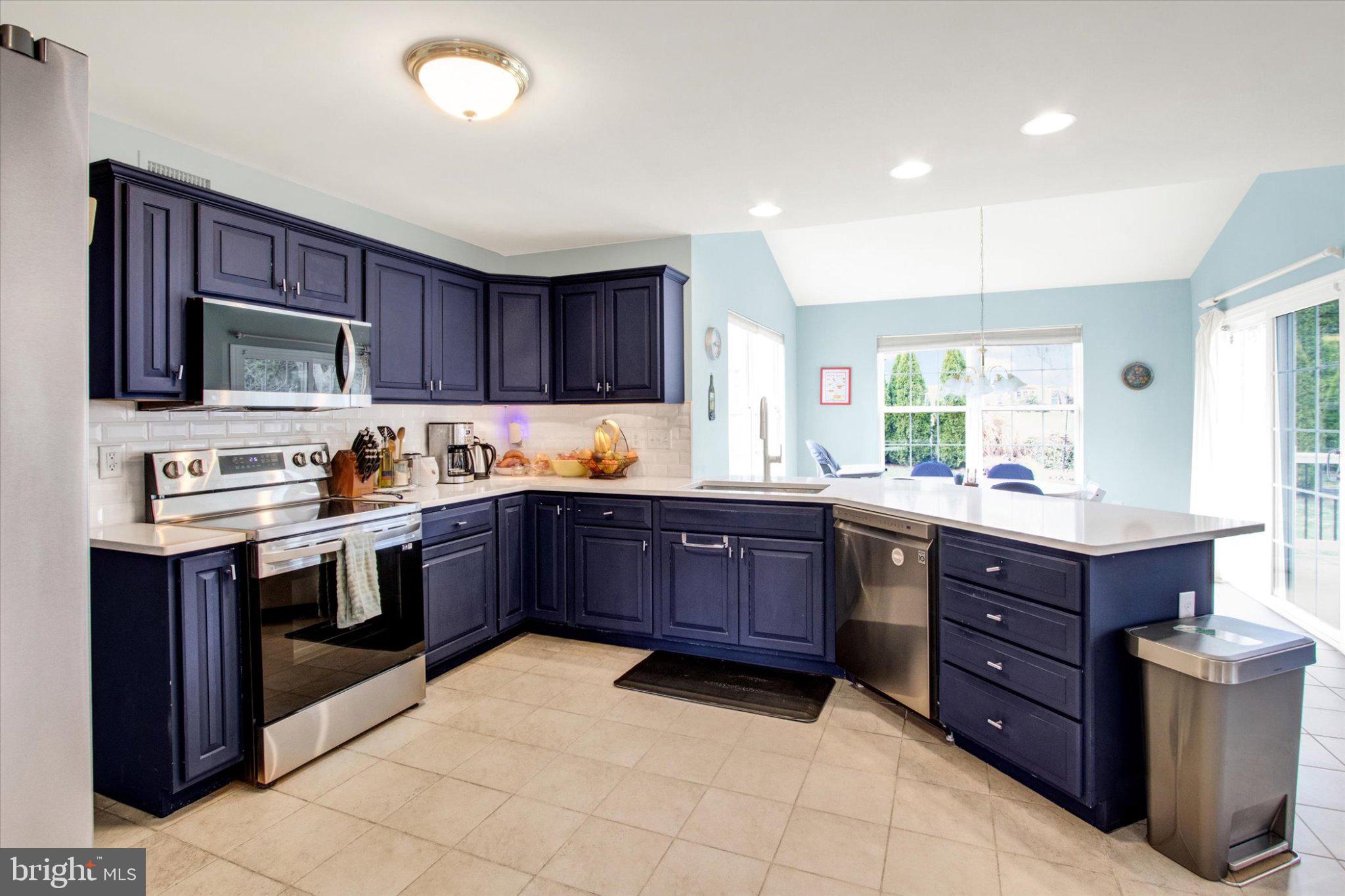 2514 Goddard Avenue Reading, PA 19608 - Photo 7 of 24 a kitchen with stainless steel appliances granite countertop a stove refrigerator and cabinets