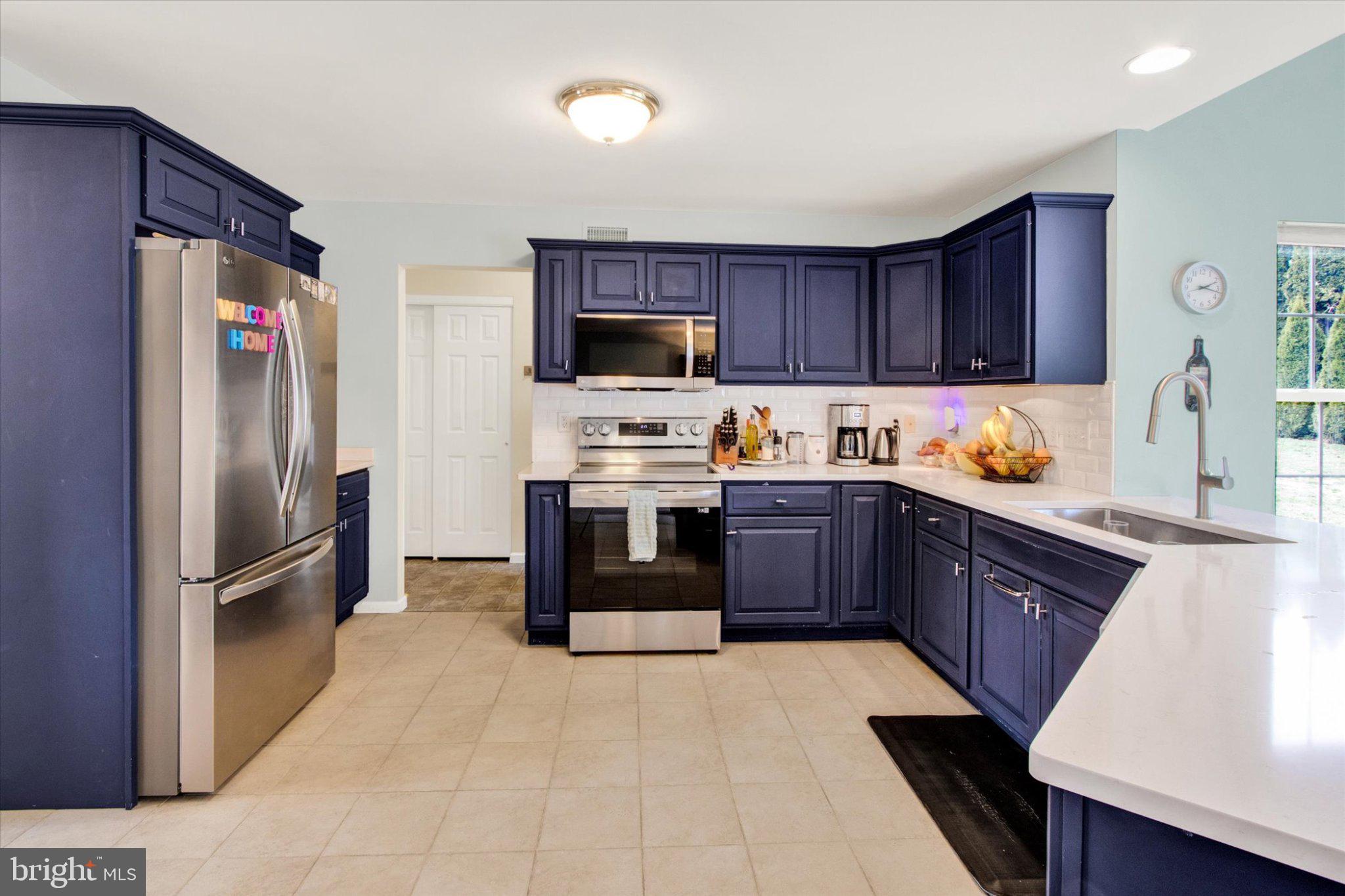 2514 Goddard Avenue Reading, PA 19608 - Photo 8 of 24 a kitchen with a refrigerator sink and wooden cabinets