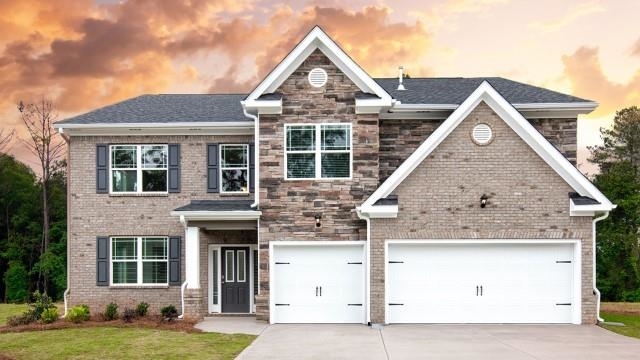 909 Eldridge Road, Unit 76 Hampton, GA 30228 - Photo 1 of 1 a front view of a house with a yard