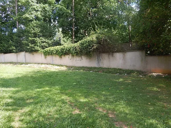 a backyard of a house with lots of green space and lake view