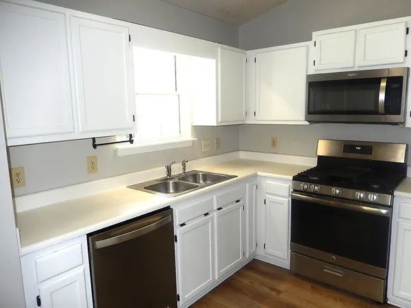 a kitchen with a sink stove and microwave