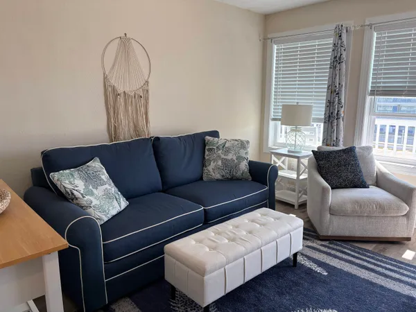 a kitchen with stainless steel appliances a stove a microwave a dining table and chairs