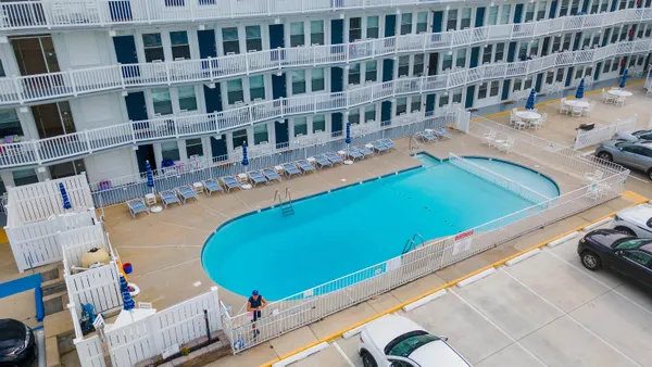 a view of a swimming pool with a lounge chairs and floor