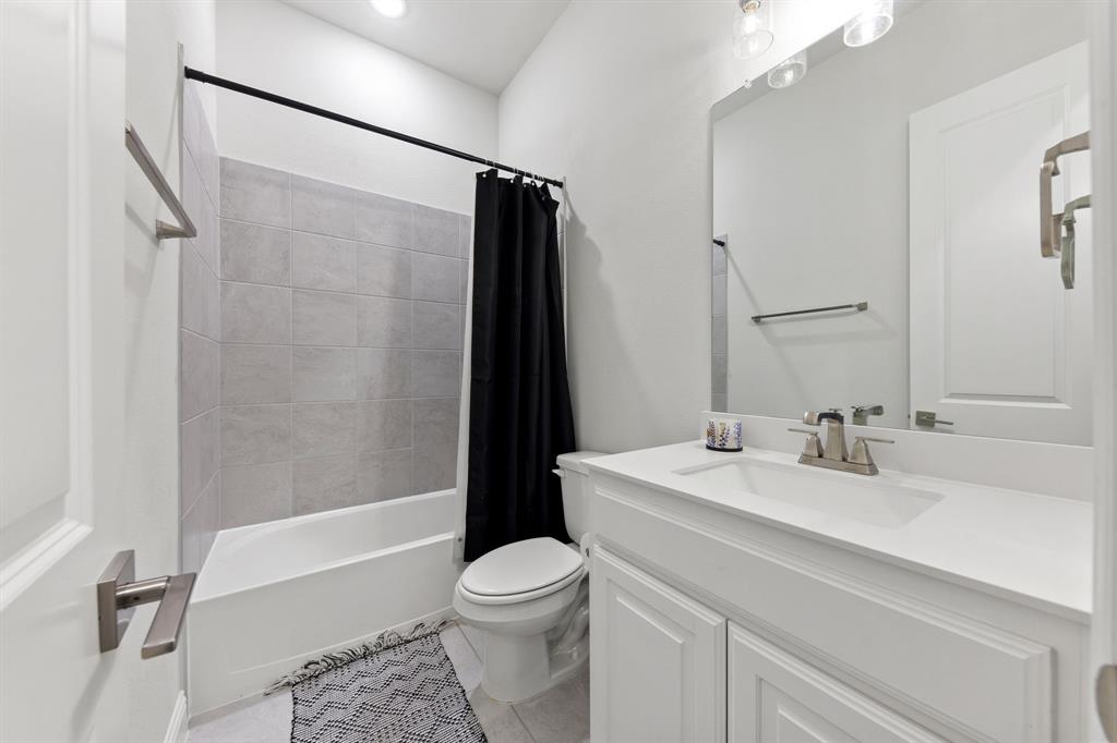 8808 Royal Star Road Rowlett, TX 75089 - Photo 28 of 40 a bathroom with a sink a toilet a mirror and shower