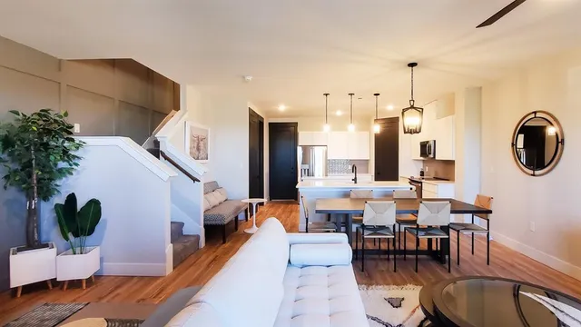a dining room with furniture and wooden floor