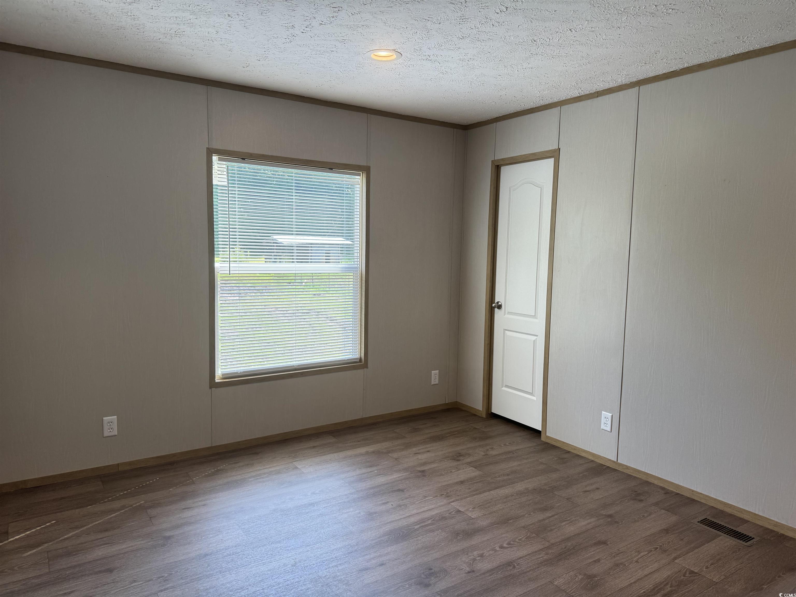 364 Jamie Road Galivants Ferry, SC 29544 - Photo 16 of 23 Spare room with wood finished floors, a textured c