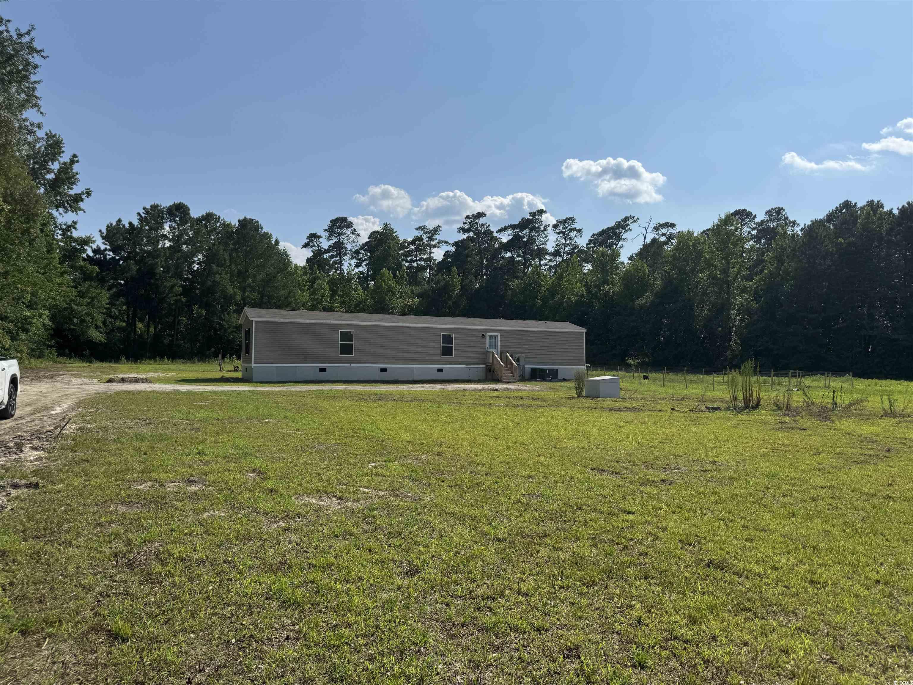 364 Jamie Road Galivants Ferry, SC 29544 - Photo 5 of 23 View of green lawn featuring a forest view